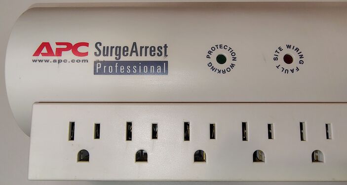 APC branding, Protection Working indicator, Site Wiring Fault indicator, and outlet detail.