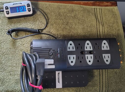 Documented weight of approximately 1 lb 12.7 oz (814 g) including attached power cord.