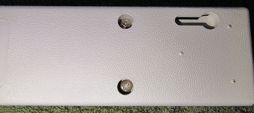 Outlet-end underside showing wall-mounting features and enclosure construction.