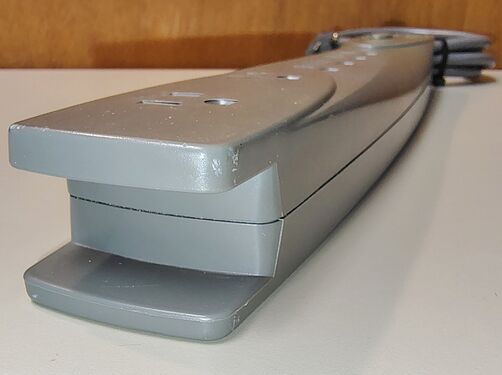 End view showing the integrated cord-storage guide used for wrapping and retaining the attached power cord.