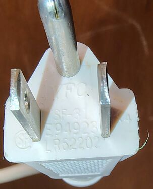 Close-up of the grounded attachment plug showing approval markings.