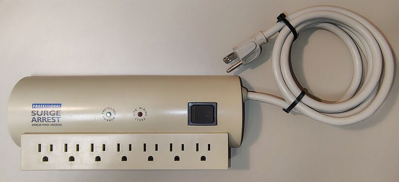 Overall view showing the seven-outlet layout, attached power cord, and early Professional SurgeArrest branding.
