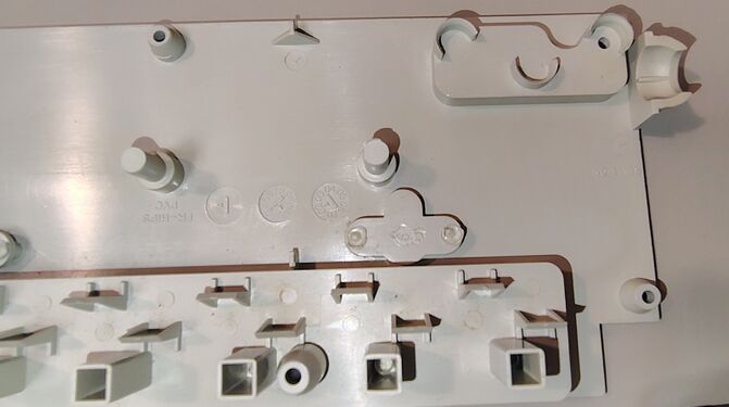 Upper housing interior showing cord-retention features, mounting structures, and outlet barriers.