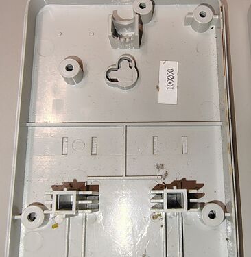 Lower enclosure details and one of the dual-orientation wall-mount keyhole slots.