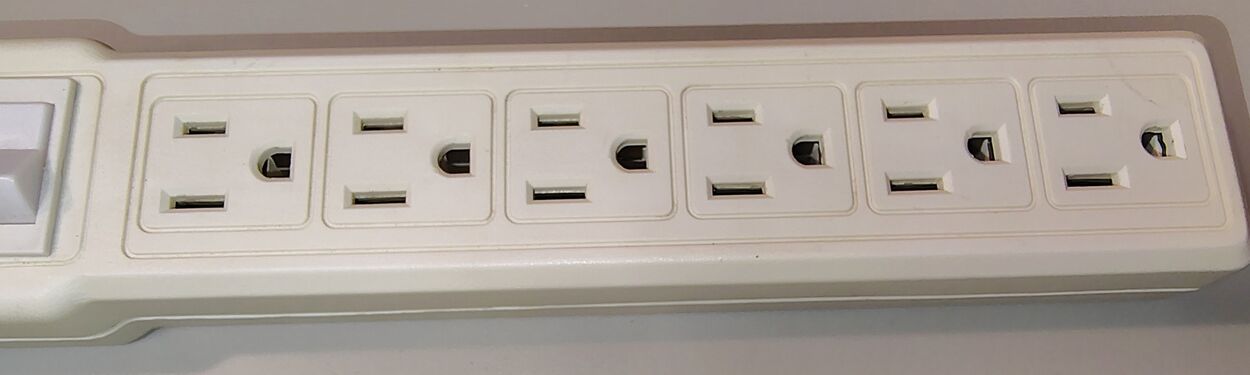 Outlet section showing six grounded receptacles arranged in a standard receptacle orientation.