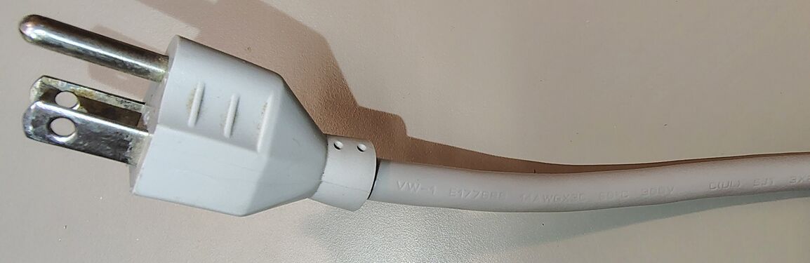 Attached grounded plug and power-cord markings.