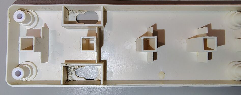 Upper housing interior showing outlet barriers and structural details.