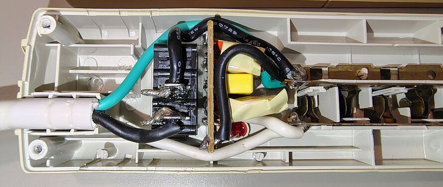 Cord-entry end showing wiring and suppression circuitry.