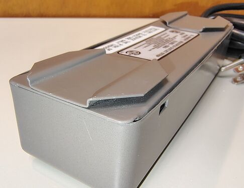 Close-up view of an underside mounting feature used to secure the unit within a Herman Miller panel-system installation.