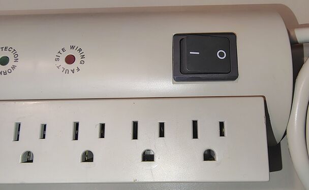 Power-switch area showing indicator layout and receptacle detail.