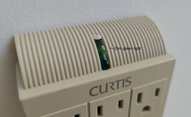 Close-up view of the illuminated green status indicator during testing.