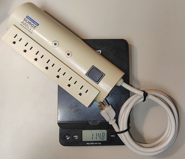 Documented weight of approximately 1 lb 14.8 oz (873 g) including the attached power cord.