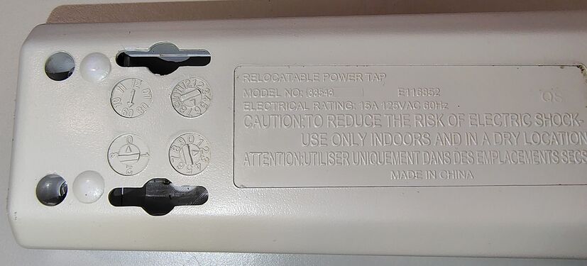 Model number, electrical ratings, date-code wheels, and safety markings.