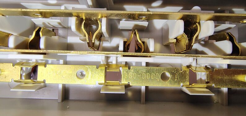 Grounding-bar markings identifying stamped component 1890-0002 revision A.