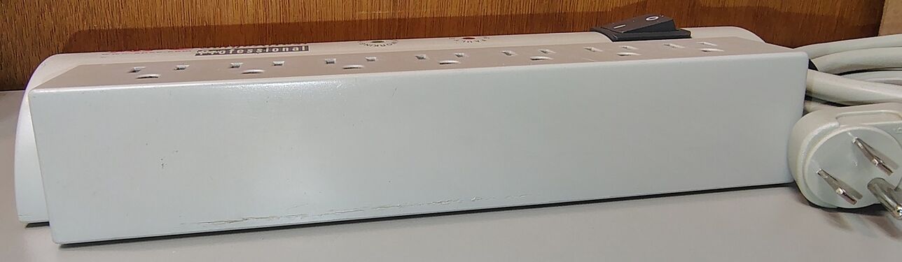 Flat-side profile showing the outlet section, enclosure construction, and overall condition.
