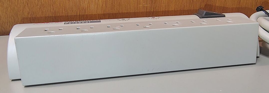 Side profile showing the rectangular receptacle section and curved upper housing.