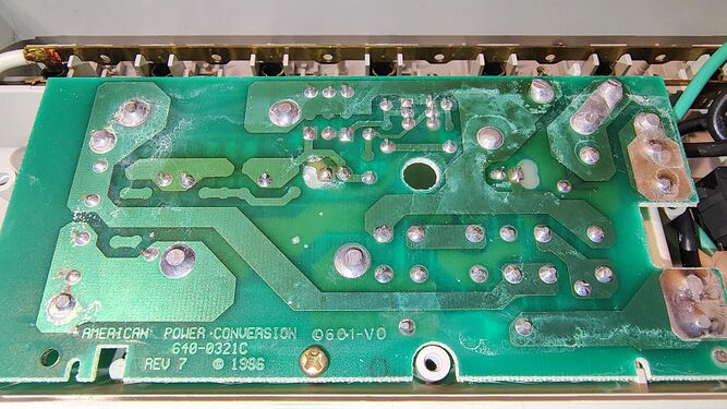 Underside of the suppression circuit board showing APC copyright markings and electrical traces.