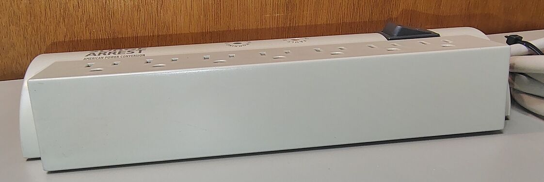 Side profile showing the flat-sided outlet section and overall enclosure design.