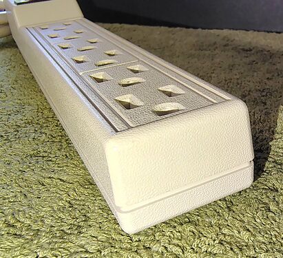 Outlet end showing the rounded enclosure profile and textured finish.