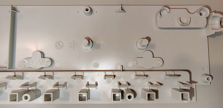 Cord-entry section of the upper enclosure showing molded supports and date wheels.