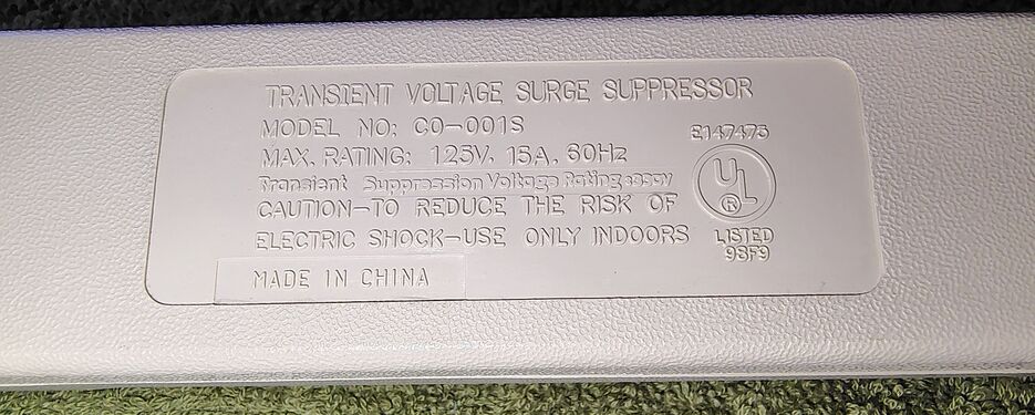 Molded regulatory-information panel showing electrical ratings and UL information.