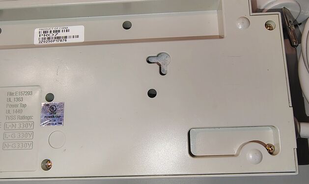 Cord-entry end underside detail showing mounting provisions and attached power cord.