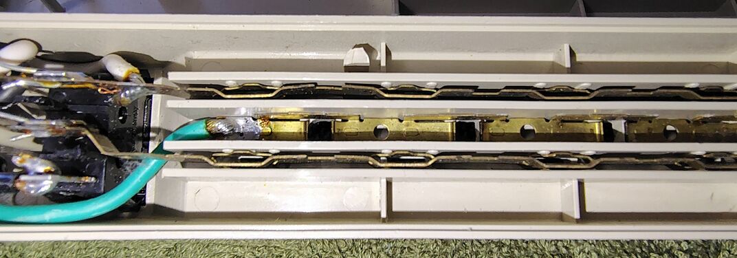 Cord-entry section showing the switch assembly, circuit breaker, wiring, and surge-suppression components.