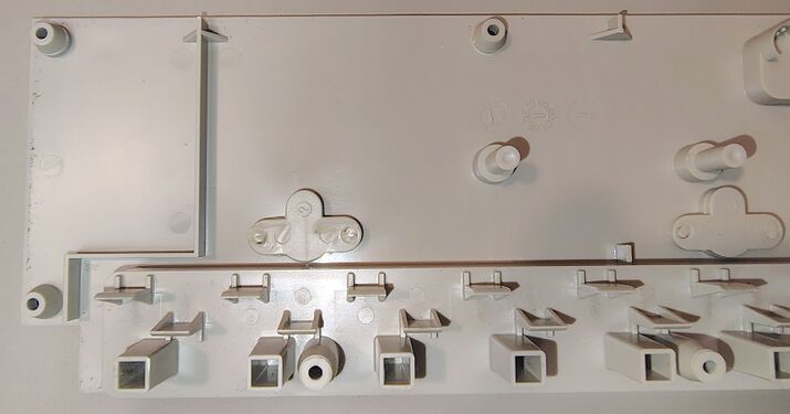 Upper housing interior showing outlet barriers, reinforcing ribs, and component-retention features.
