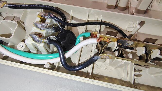 Close-up of the epoxy-encapsulated surge-suppression assembly.