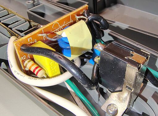 Outlet-contact assembly showing stamped power-distribution conductors and receptacle supports.