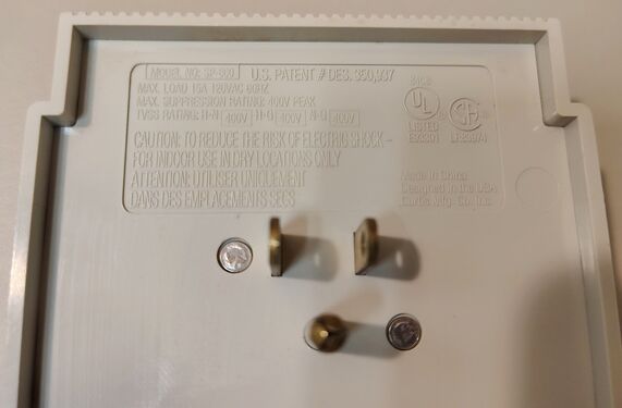 Data plate showing model information, electrical ratings, certifications, patent marking, and manufacturing details.