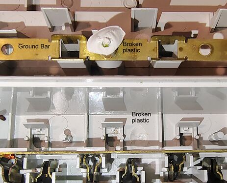Fractured mounting boss and grounding-bus-bar attachment point.