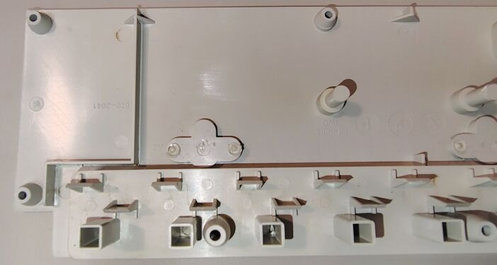 Upper housing interior showing outlet supports, barriers, and structural details.