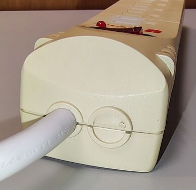 Cord-entry end showing the control section and unused knockout.
