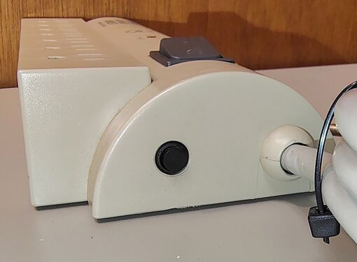 Cord-entry end showing strain relief, enclosure profile, and switch location.