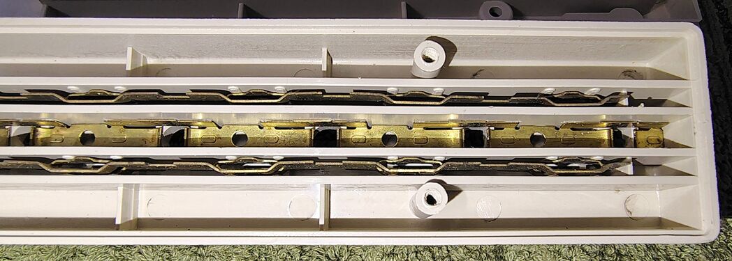 Stamped-metal outlet-contact assembly providing power distribution to all six receptacles.