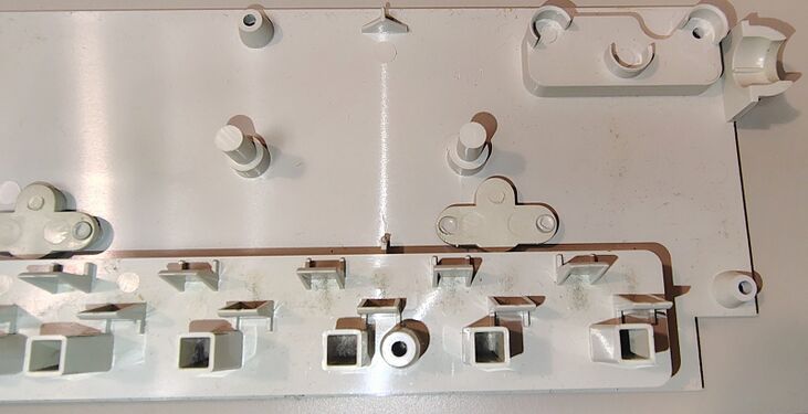Interior of the upper enclosure showing molded outlet supports, switch mounting features, and enclosure details.