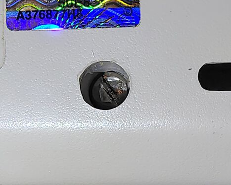 Security screw and date-code wheels visible on the underside of the enclosure.