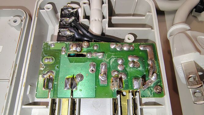 Underside of the main surge suppression board and illuminated circuit breaker assembly.
