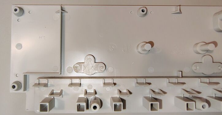 Interior of the upper enclosure showing structural features and molded date wheels.