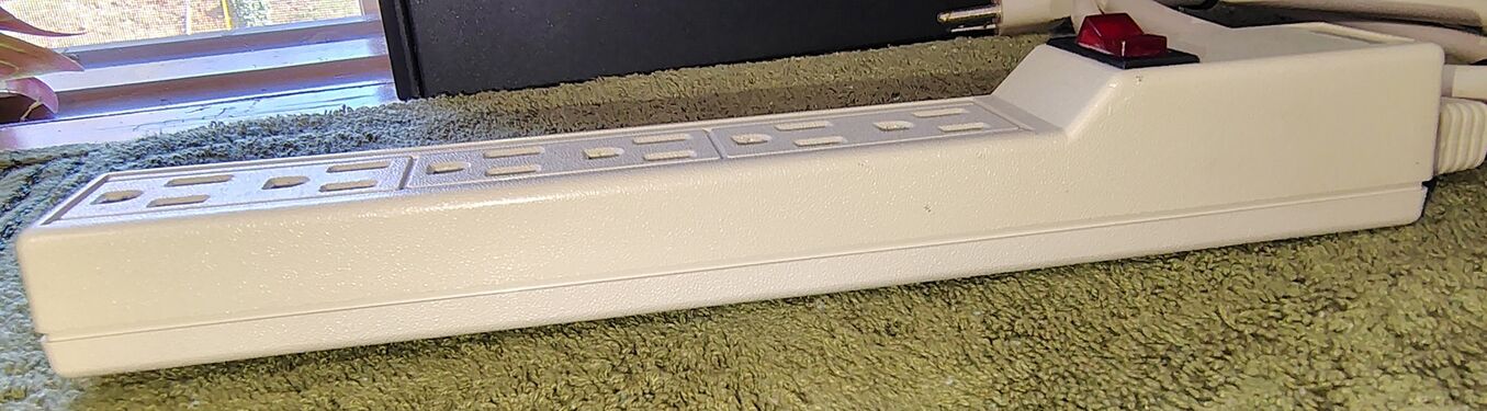Cord-entry side showing the strain-relief assembly and rocker switch.