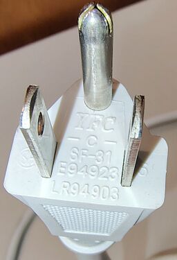 Close-up of the grounded NEMA 5-15P plug showing molded approval markings.