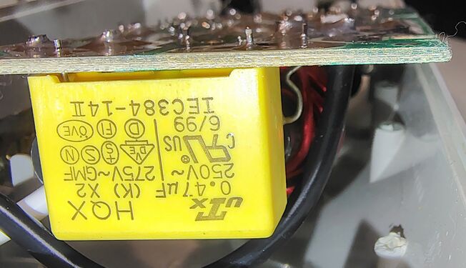 Filtering capacitor marked June 1999 and associated suppression components.