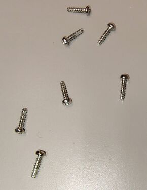 Seven Phillips-head screws secure the enclosure halves.