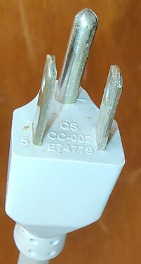 Grounded attachment plug showing manufacturer markings and UL file number.