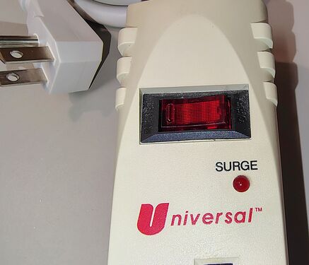 Control section showing the RESET/OFF rocker switch, SURGE indicator, and Universal branding.