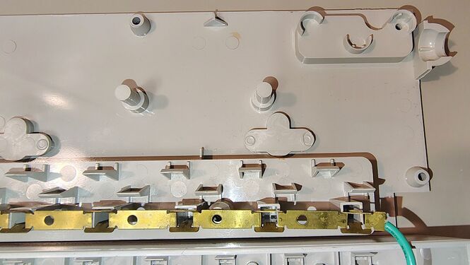 Upper housing interior showing outlet supports, grounding bus bar, and structural details.