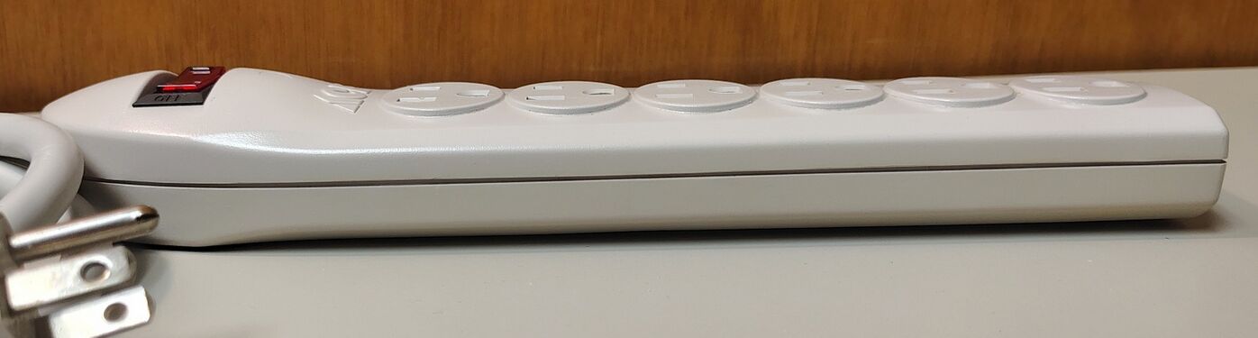 Right-side profile showing the rocker-switch section, enclosure taper, and cord-entry end.