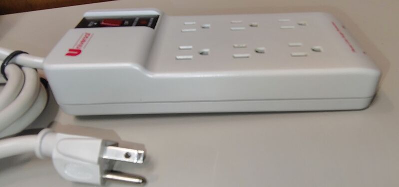 Left-side profile view with attached power cord.