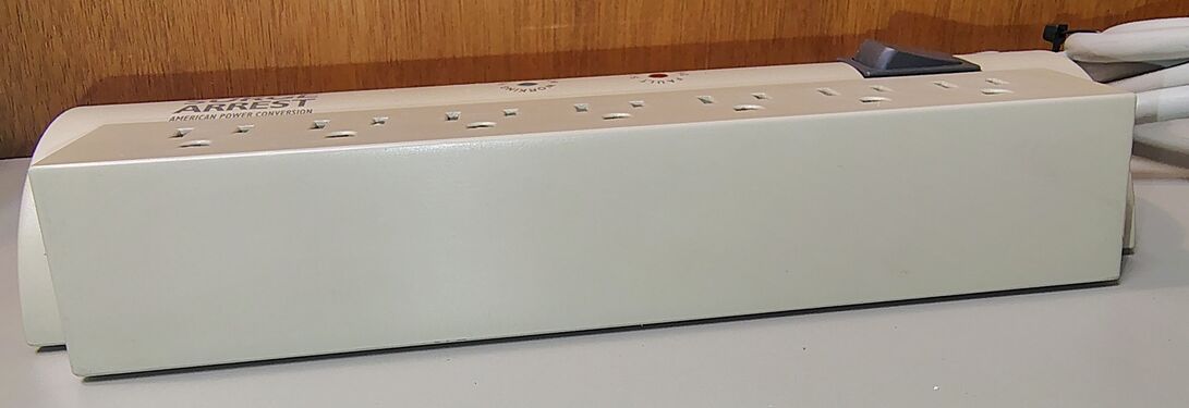 Side profile showing the seven-outlet section and rectangular lower enclosure.